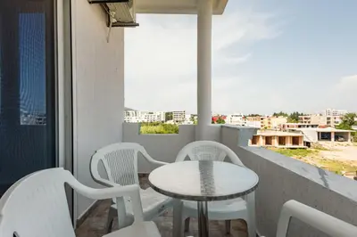 a table and chairs on a balcony with a view at Kraja Apartments in Ulcinj