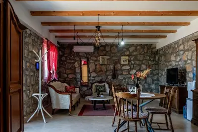 a living room with a table and chairs at Stara Kruska in Podgorica