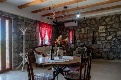 a dining room with a table and chairs at Stara Kruska in Podgorica