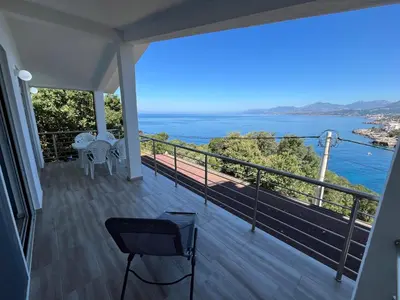 a balcony with a view of the ocean at Jakovljevic apartman in Utjeha