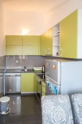 a kitchen with lime green cabinets and a sink at Apartments Vila Masha in Petrovac na Moru