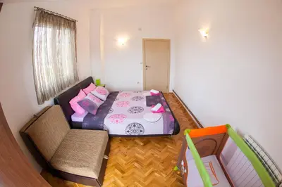 a small room with a bed and a couch at Apartments Vila Masha in Petrovac na Moru