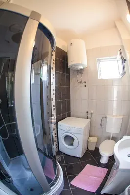 a small bathroom with a toilet and a sink at Apartments Vila Masha in Petrovac na Moru