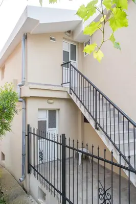 a house with a staircase in front of it at Apartments Vila Masha in Petrovac na Moru