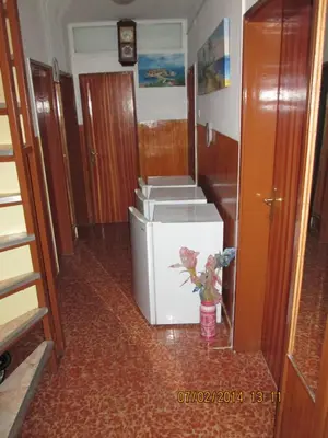a room with a refrigerator and a vase of flowers at Guest House Ivo Jovanovic in Sveti Stefan
