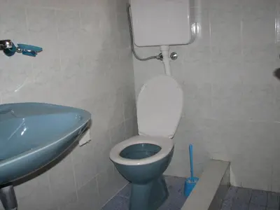 a bathroom with a toilet and a sink at Guest House Ivo Jovanovic in Sveti Stefan