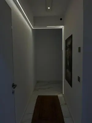 a hallway with a door and a rug on the floor at One bedroom apartments Budva in Budva