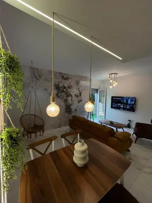 a living room with a couch and a table at One bedroom apartments Budva in Budva