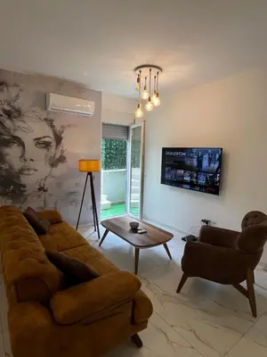 a living room with a couch and a table at One bedroom apartments Budva in Budva