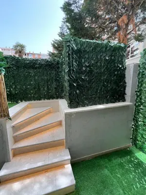 a garden with stairs and a green hedge at One bedroom apartments Budva in Budva