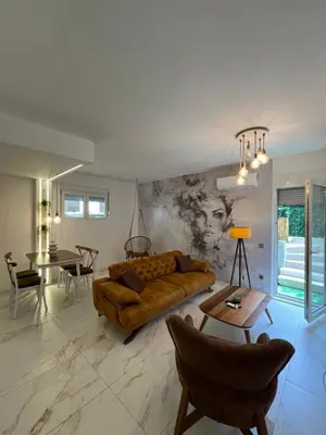 a living room with a couch and a table at One bedroom apartments Budva in Budva