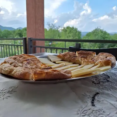 a plate of bread and pastries on a table at Oasis of Peace Meterizi in Cetinje