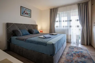 a bedroom with a bed and a large window at Oasis of Peace Meterizi in Cetinje