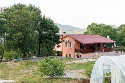 a house with a greenhouse in front of it at Oasis of Peace Meterizi in Cetinje