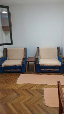 two blue chairs sitting in a room with a mirror at Apartman Vesna Budva 1 in Budva