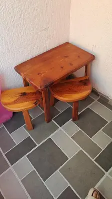 a wooden table with a bench and a table and stool at Apartman Vesna Budva 1 in Budva