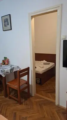 a room with a bed and a table and a mirror at Apartman Vesna Budva 1 in Budva