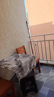 a table with a blanket on a chair in a room at Apartman Vesna Budva 1 in Budva
