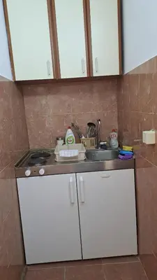 a kitchen with white cabinets and a sink at Apartman Vesna Budva 1 in Budva