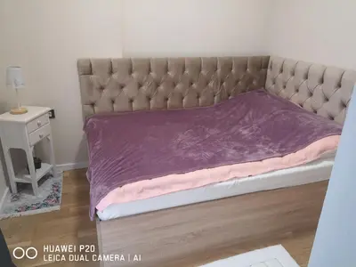 a bed with a purple blanket on top of it at Život je tren in Podgorica