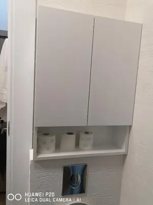 a white cabinet with some knick knacks on a shelf at Život je tren in Podgorica