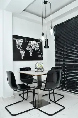 a dining room with a table and black chairs at La splendida in Becici