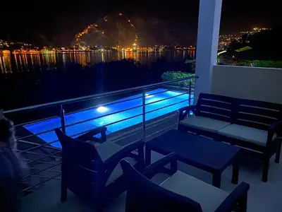 a balcony with a table and chairs and a view of the water at Luxury Kotor bay view studio in Muo