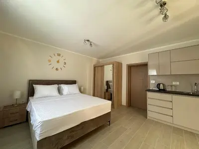 a bedroom with a bed and a clock on the wall at Luxury Kotor bay view studio in Muo