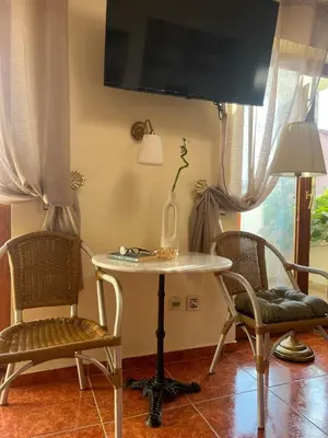 a table and chairs in a room with a tv at Villa M in Becici
