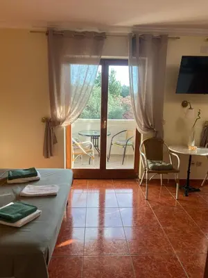 a living room with a couch and a table at Villa M in Becici