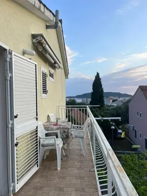 a balcony with a table and chairs and a view at Villa M in Becici