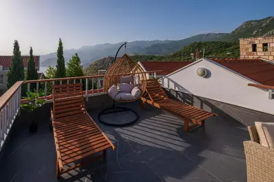 two wooden benches on a balcony with a swing at Carsko Selo Budva Blizikuce Soppp in Ðenaši