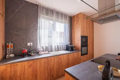 a kitchen with a window and a counter with a microwave at Carsko Selo Budva Blizikuce Soppp in Ðenaši