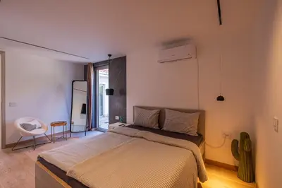a bedroom with a bed and a chair in it at Carsko Selo Budva Blizikuce Soppp in Ðenaši