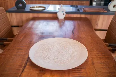 a plate sitting on top of a wooden table at Carsko Selo Budva Blizikuce Soppp in Ðenaši