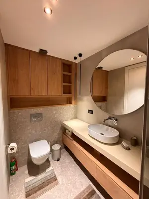 a bathroom with a toilet and a sink and a mirror at Giardino Onia Apartment in Budva