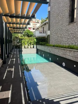 a swimming pool in the middle of a building at Giardino Onia Apartment in Budva