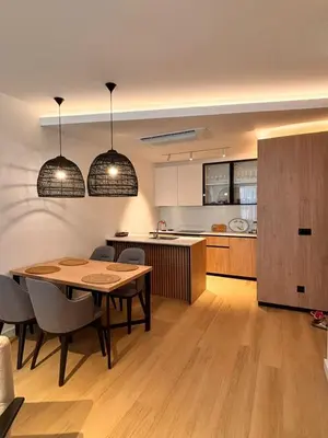 a kitchen and dining room with a table and chairs at Giardino Onia Apartment in Budva