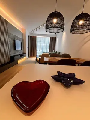 a heart shaped plate on a table in a living room at Giardino Onia Apartment in Budva