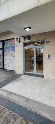 a building with a glass door on a sidewalk at Vacation Apartment City Kvart in Podgorica