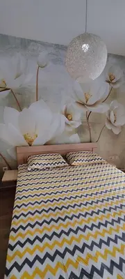 a mural of white flowers on a wall at Vacation Apartment City Kvart in Podgorica