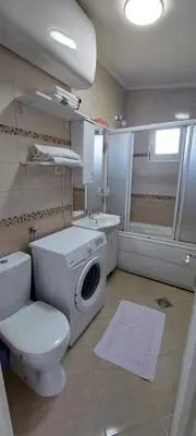 a bathroom with a toilet and a washing machine at Apartment Diki in Bar