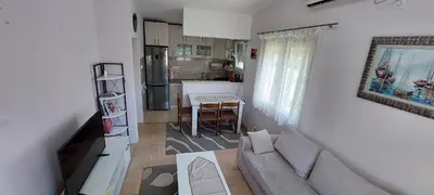 a living room with a couch and a kitchen at Apartment Diki in Bar