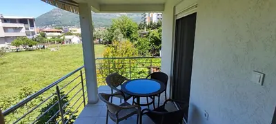 a balcony with a blue table and chairs on it at Apartment Diki in Bar