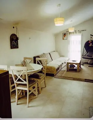 a living room with a bed and a table and chairs at Bgd 2 apartman in Kotor