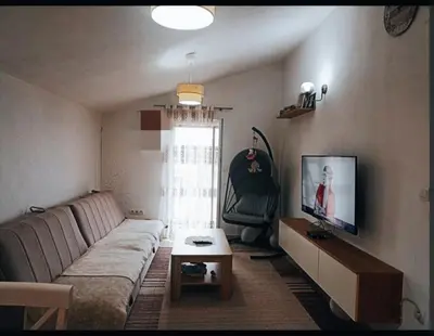 a living room with a couch and a chair at Bgd 2 apartman in Kotor