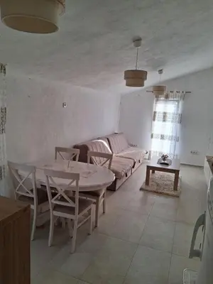 a living room with a table and a couch at Bgd 2 apartman in Kotor