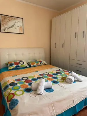 a bedroom with a bed with a colorful comforter at Apartmani VV in Cetinje