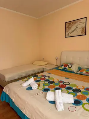 a bedroom with two beds with towels on them at Apartmani VV in Cetinje