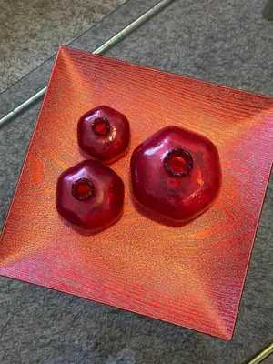 two cherries sitting on top of a red plate at Apartmani VV in Cetinje